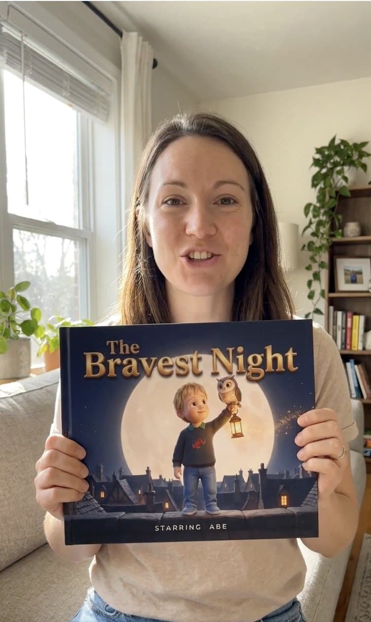 A grown up holding a copy of The Bravest Night